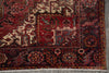 Load image into Gallery viewer, Close-up of a patterned rug with intricate designs on a gray floor.