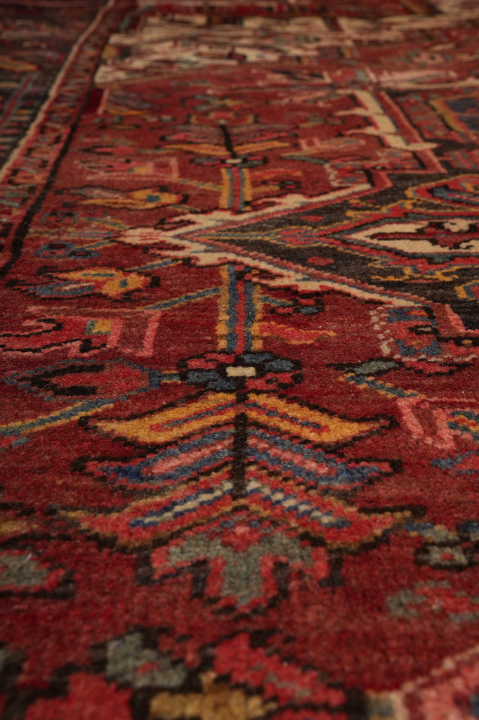 Close-up of a patterned red rug with intricate designs