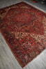 Load image into Gallery viewer, Vintage red and brown patterned rug on a gray floor
