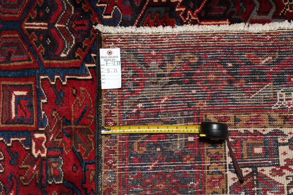 Decorative rug with a measuring tape and a small object on top, showing measurements.