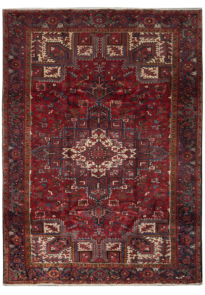 A traditional oriental rug with a deep red field, featuring a central medallion, geometric borders, and cream, blue, and brown details.