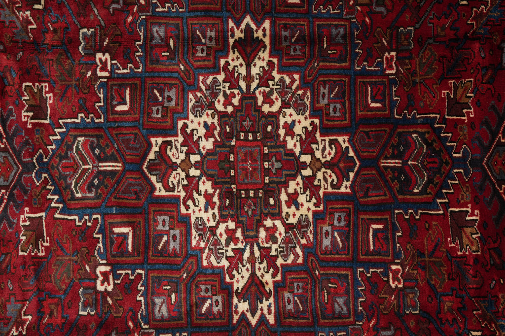 Close-up of a patterned rug with red and beige colors