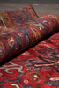 Load image into Gallery viewer, Close-up of a patterned red and blue rug with intricate designs.