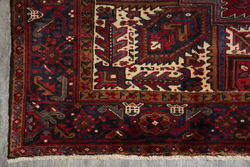 Close-up of an intricately designed rug with geometric patterns on a gray surface.