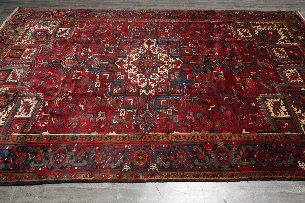 Red patterned rug on a wooden floor