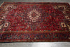 Load image into Gallery viewer, Red patterned rug on a wooden floor