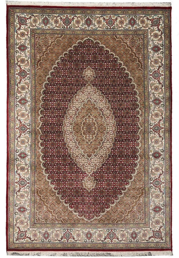 A traditional oriental area rug with an intricate floral pattern, featuring a large central oval medallion in deep red-brown, surrounded by beige and cream borders.