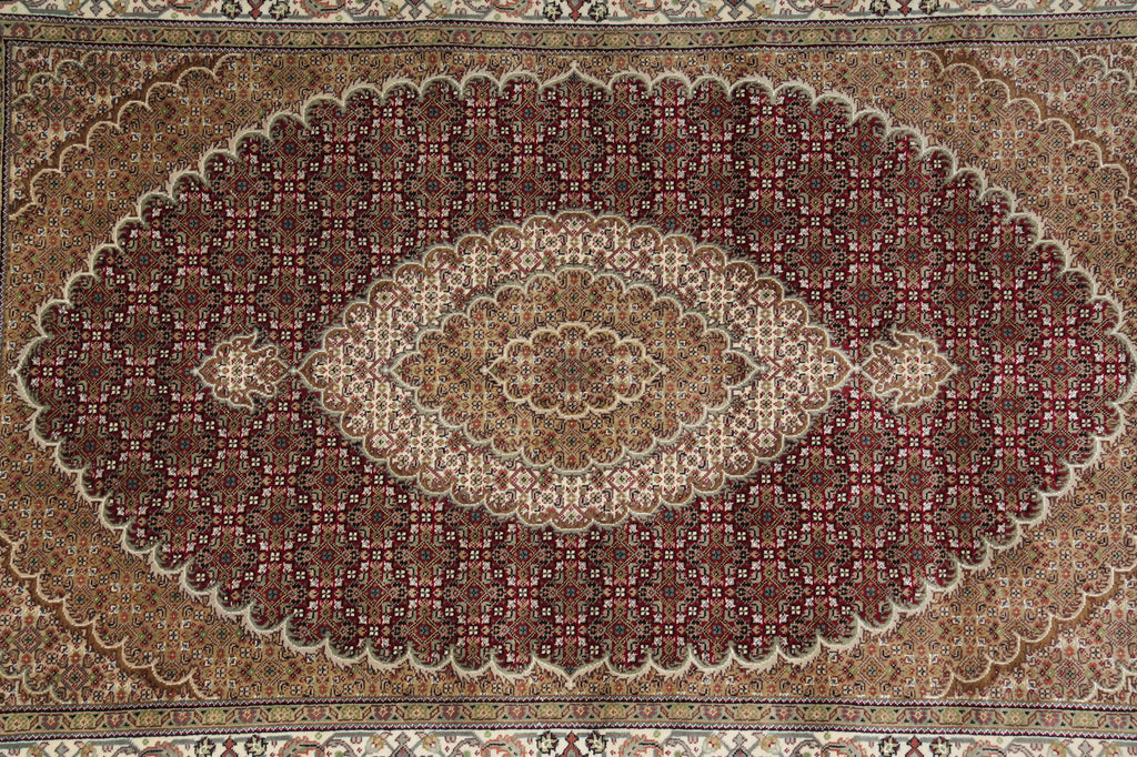 Close-up of a patterned rug with intricate designs.