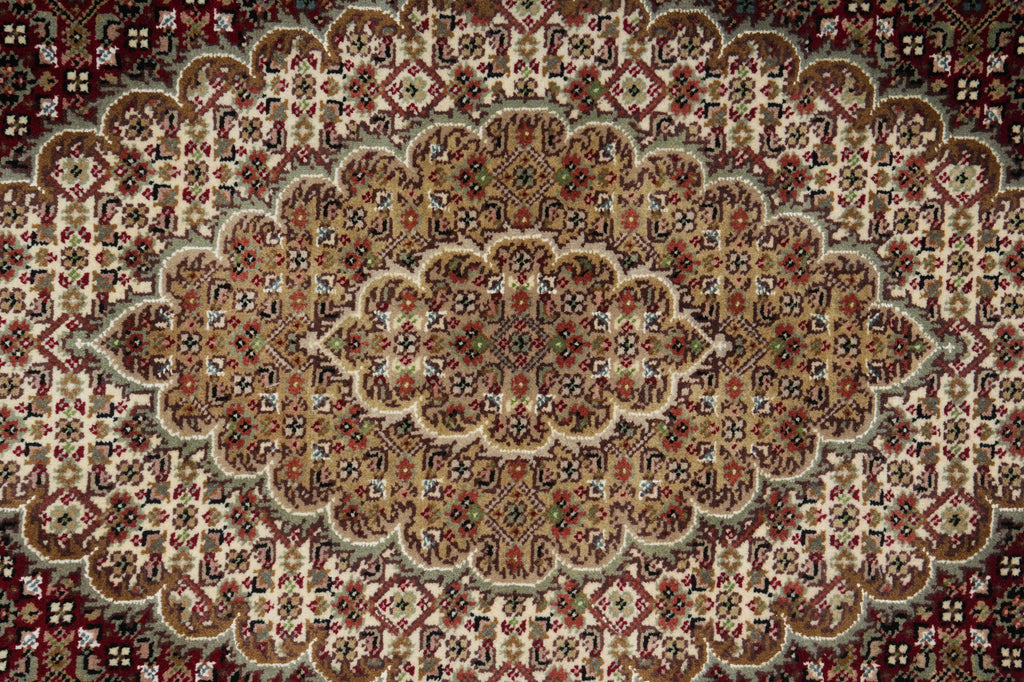 Close-up of a patterned rug with intricate designs.