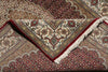 Load image into Gallery viewer, Close-up of a patterned rug with intricate designs and red border.
