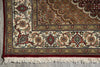Load image into Gallery viewer, Close-up of a patterned rug with intricate designs on a gray floor.