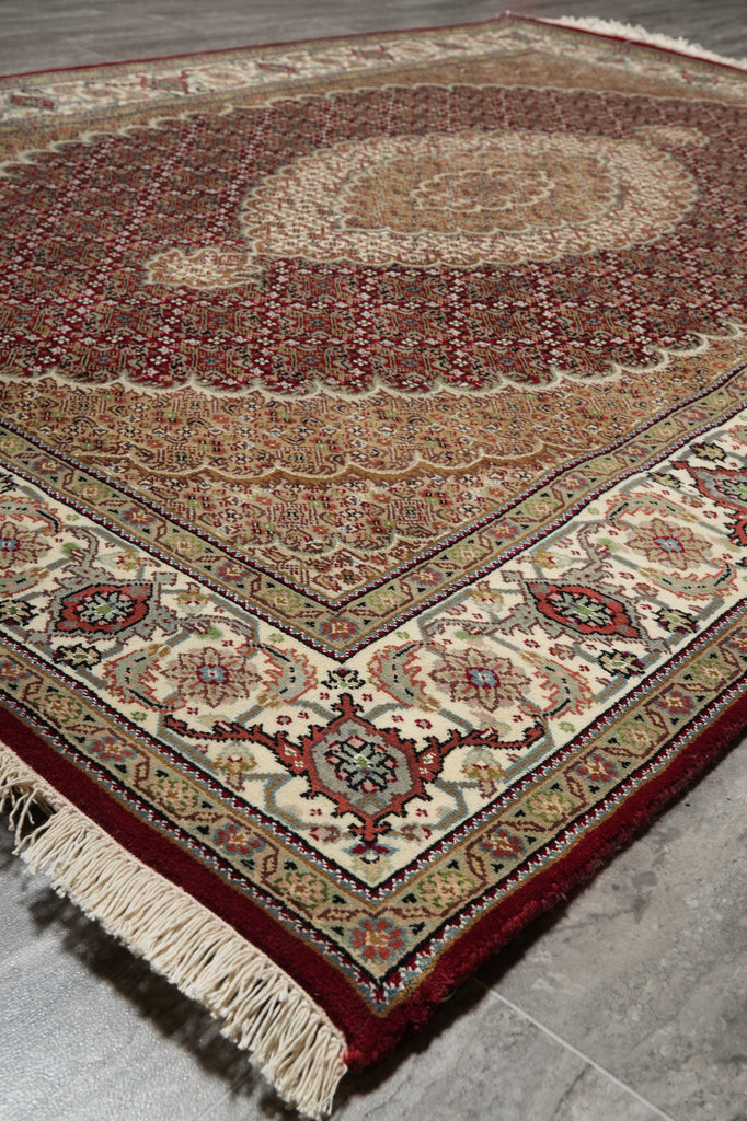 Decorative rug with intricate patterns on a tiled floor
