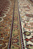 Load image into Gallery viewer, Close-up of an intricately patterned rug with detailed designs.