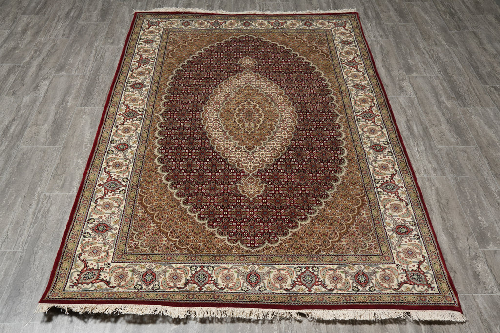 Decorative rug with intricate patterns on a wooden floor