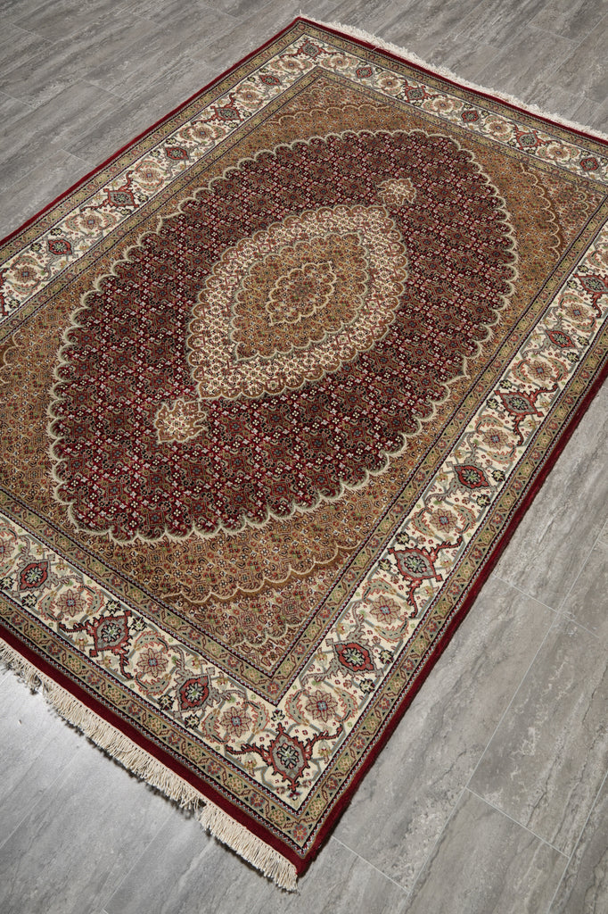 Decorative rug with intricate patterns on a wooden floor