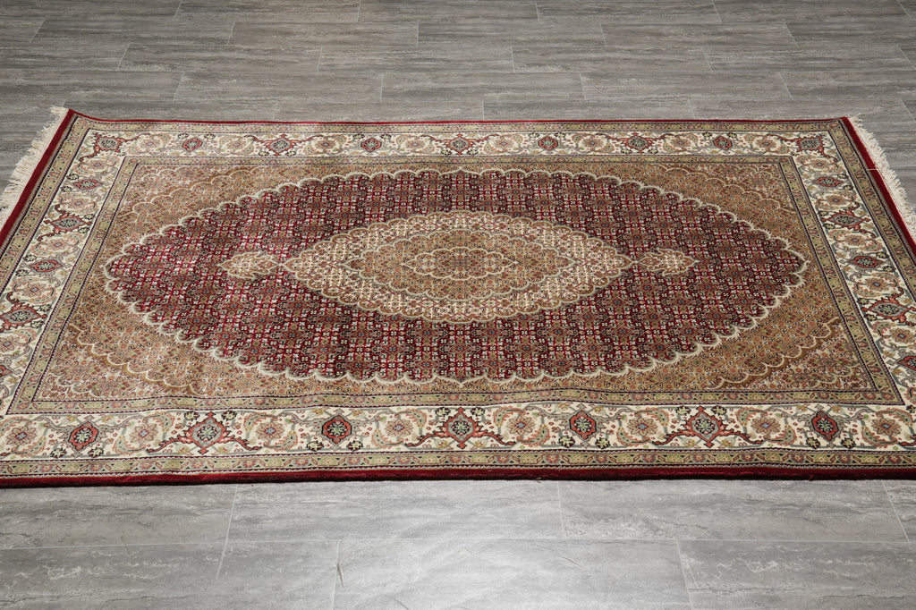Decorative rug with intricate patterns on a wooden floor