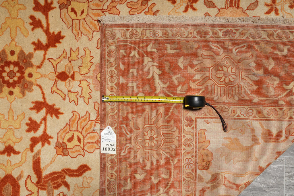 Close-up of a patterned rug with a measuring tape on top