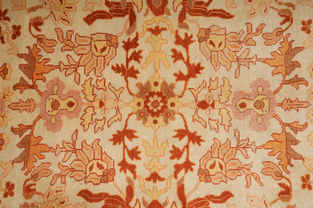 Close-up of a patterned rug with intricate designs in brown and beige.