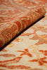 Load image into Gallery viewer, Close-up of textured fabric with a floral pattern in shades of orange and beige.
