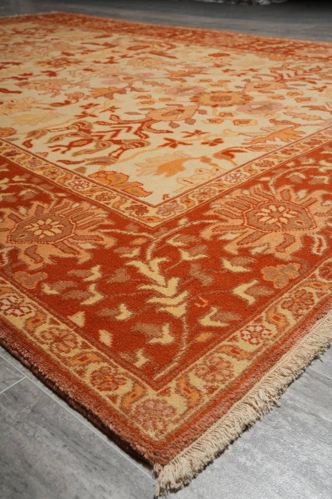 Close-up of a red patterned rug on a wooden floor