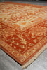 Load image into Gallery viewer, Close-up of a red patterned rug on a wooden floor