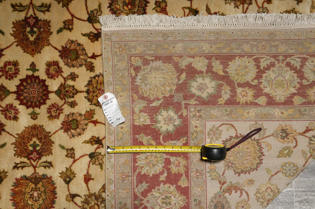Decorative rug with a measuring tape on top, showing measurement details.