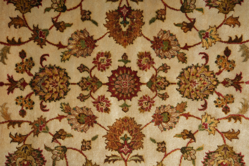 Close-up of a patterned rug with intricate designs on a beige background