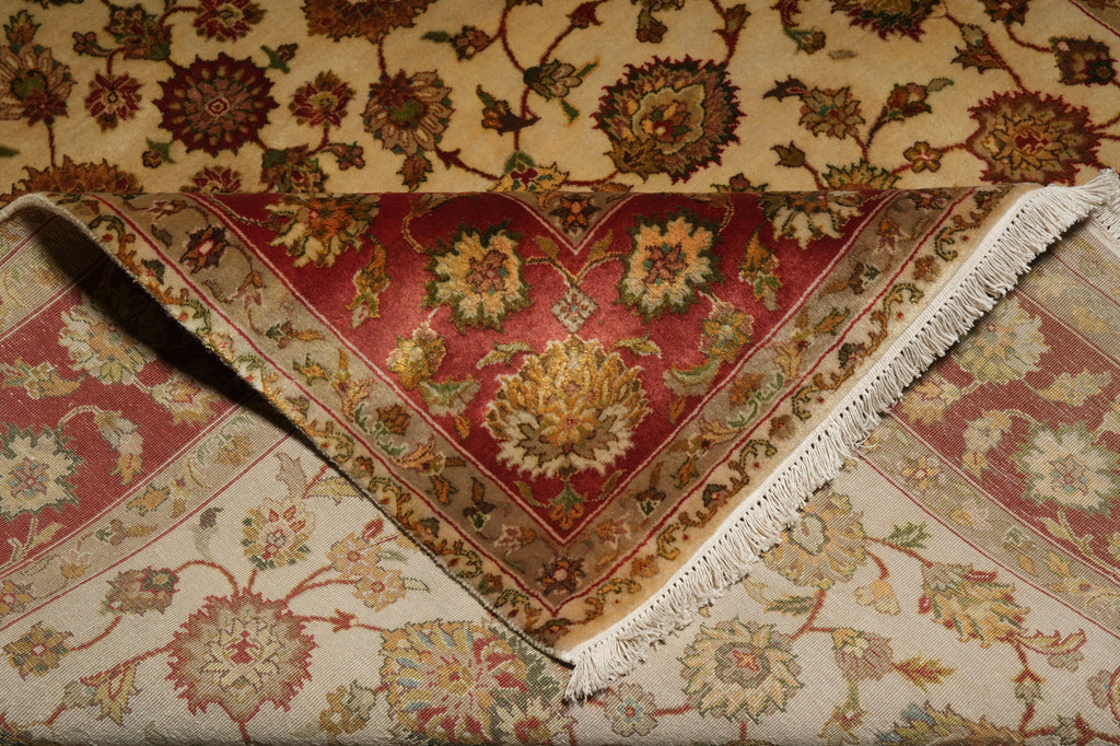 Close-up of a patterned rug with intricate designs and fringes.