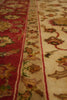 Load image into Gallery viewer, Close-up of a patterned rug with red and beige colors