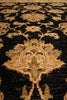 Load image into Gallery viewer, Close-up of a patterned rug with intricate designs on a dark background