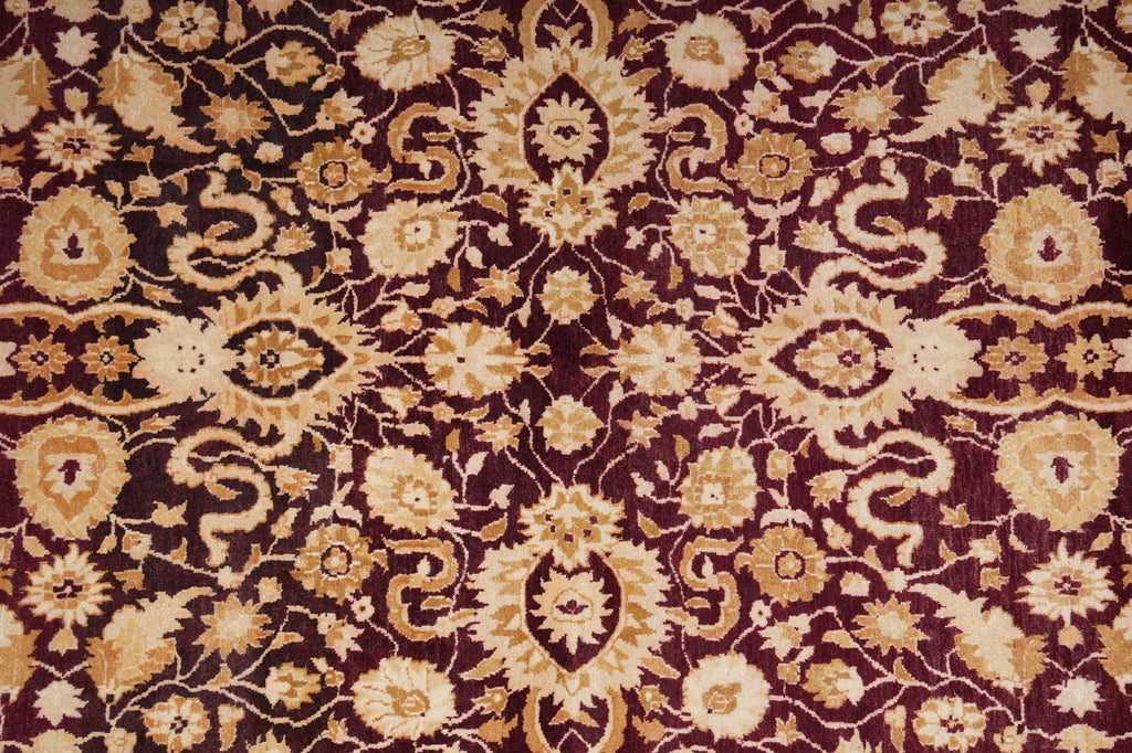 Close-up of a patterned fabric with floral and geometric designs in brown and beige.