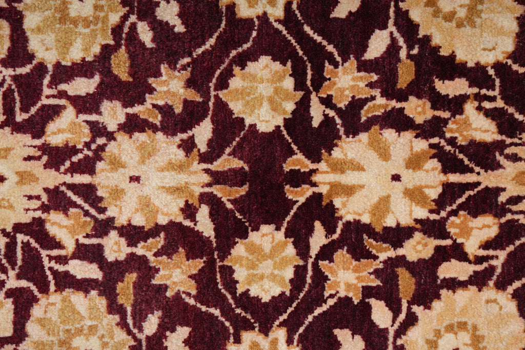 Close-up of a patterned rug with floral design on a dark background