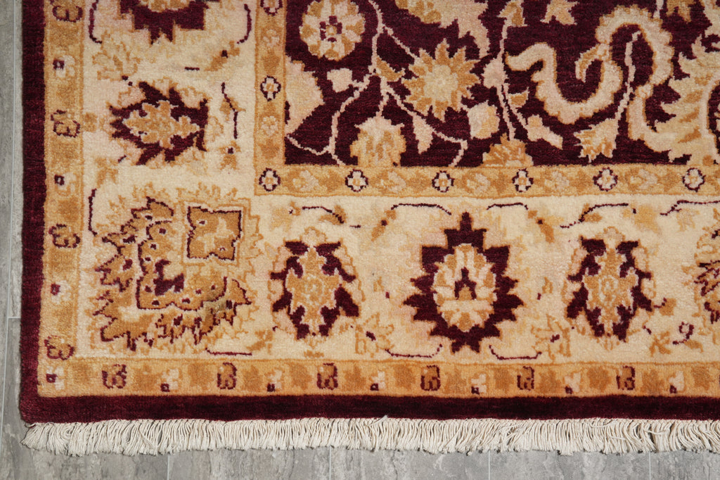 Close-up of a patterned rug with intricate designs on a neutral background