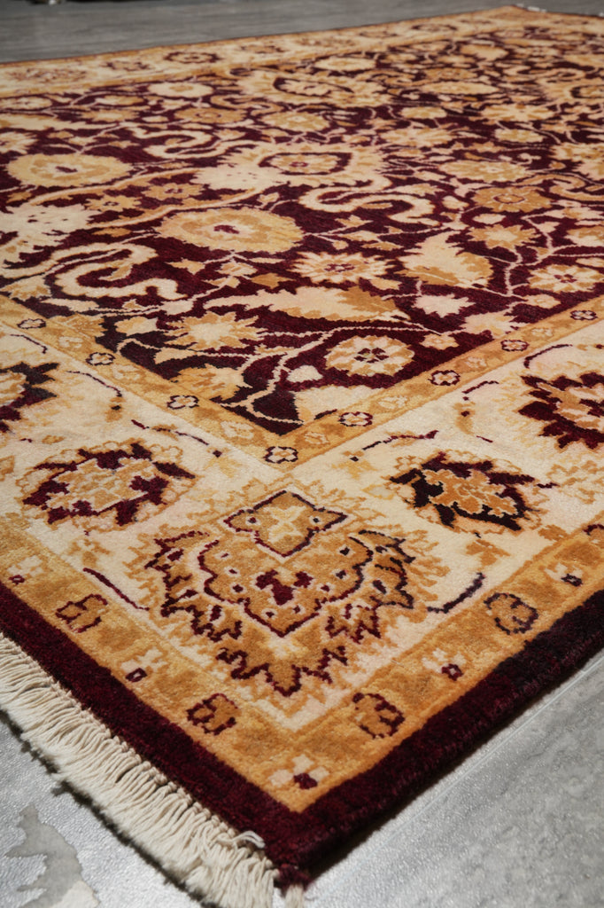 Close-up of a patterned rug with intricate designs on a plain background