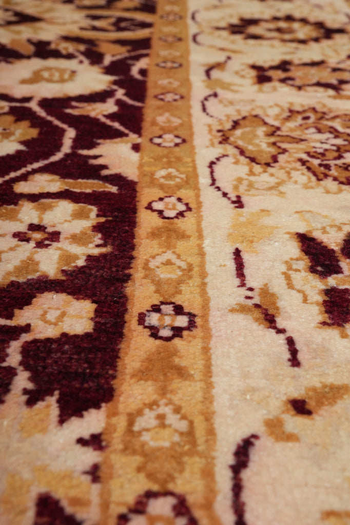 Close-up of a patterned rug with brown and beige colors