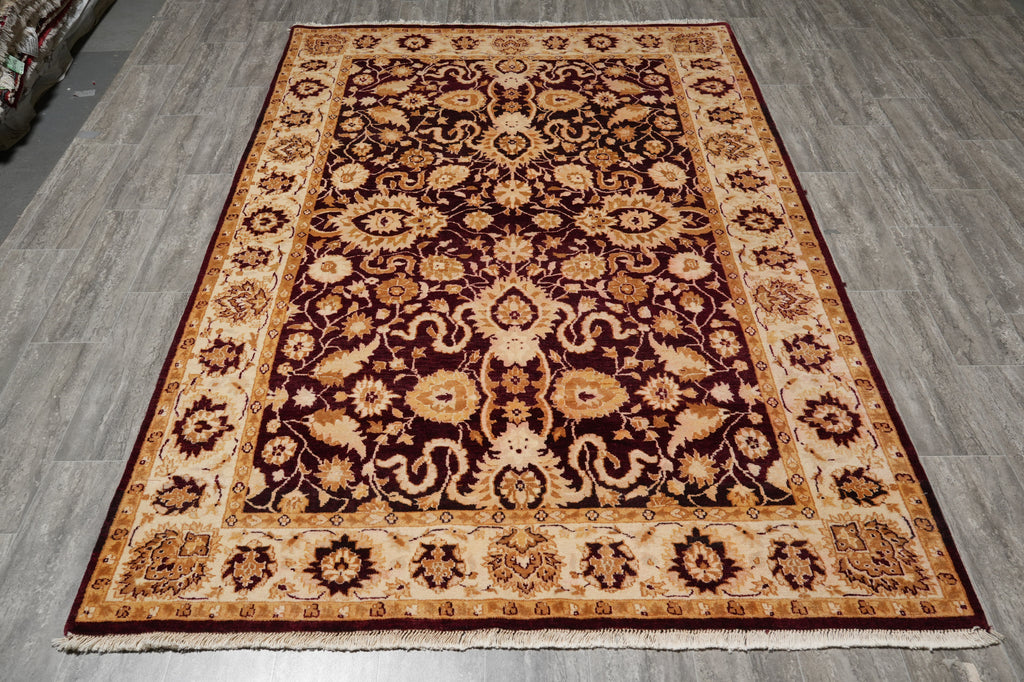 Decorative rug with intricate patterns on a gray floor