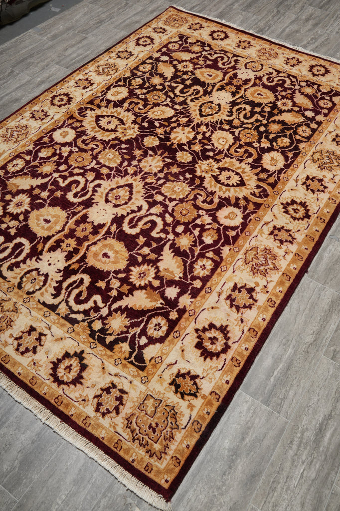 Decorative rug with intricate patterns on a wooden floor