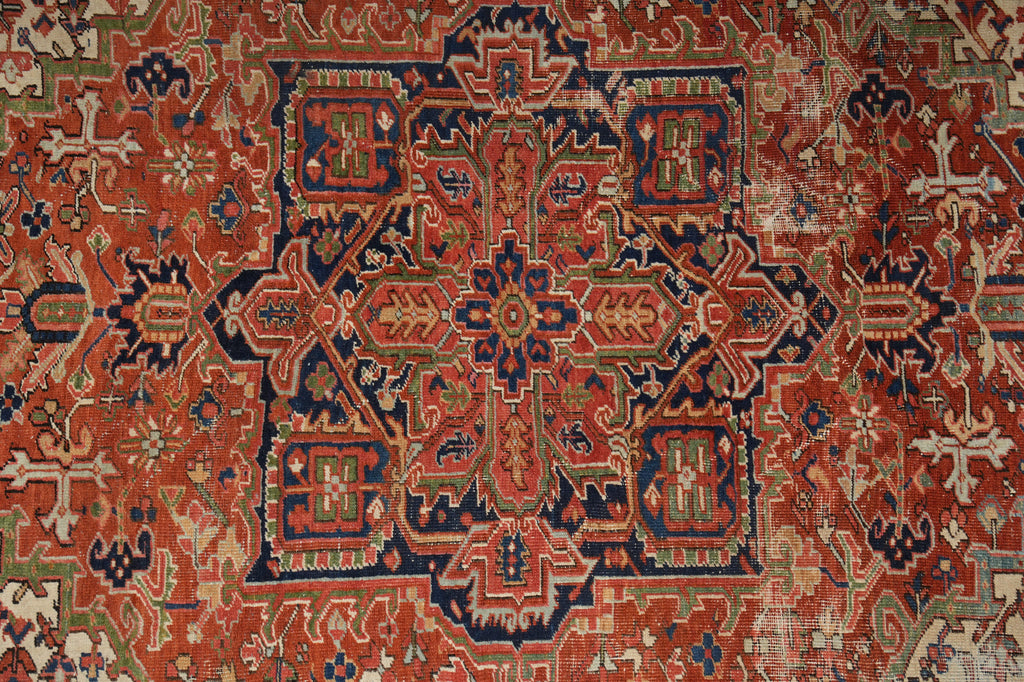 Close-up of an intricately designed rug with red, blue, and beige colors.