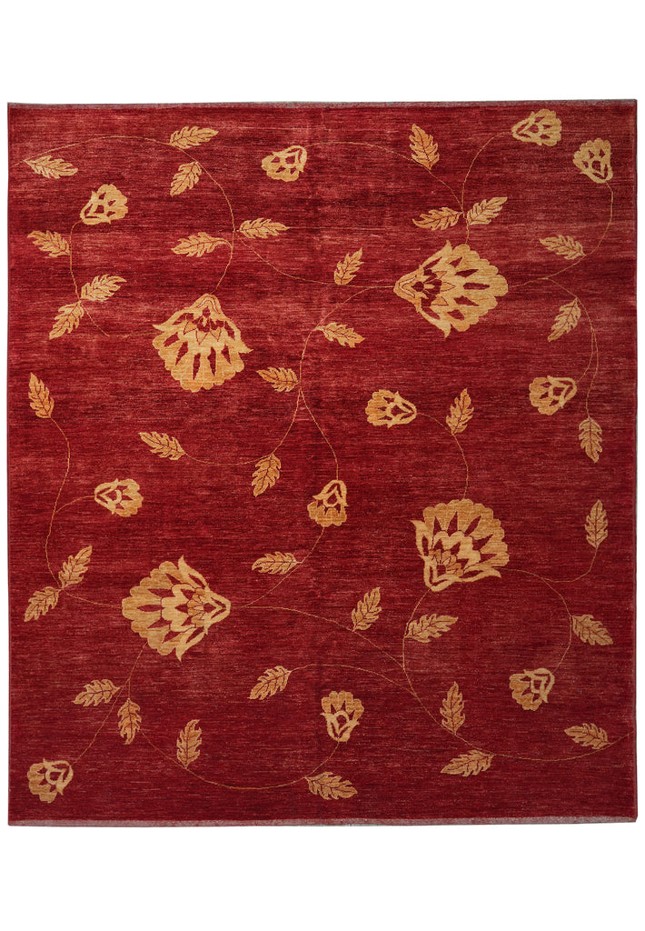 Red rug with gold floral patterns on a white background