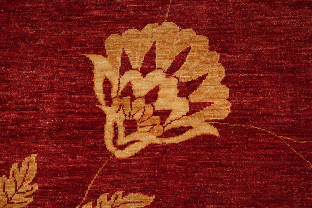 Close-up of a textured red fabric with gold floral patterns