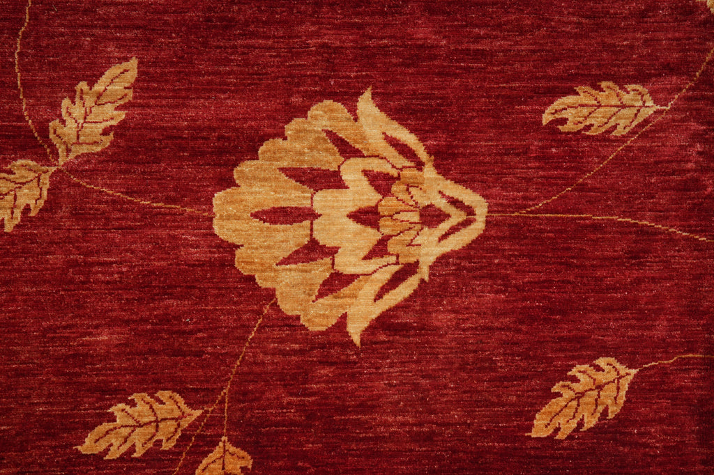 Close-up of a red fabric with gold leaf patterns