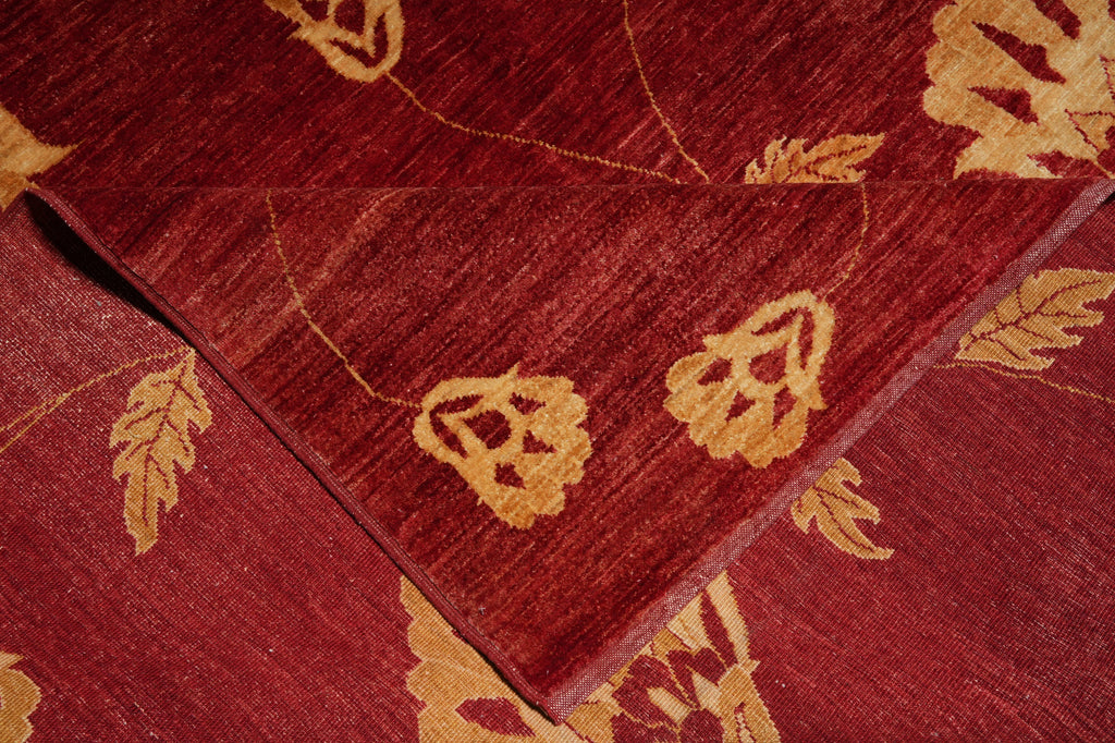 Close-up of a red rug with gold leaf patterns