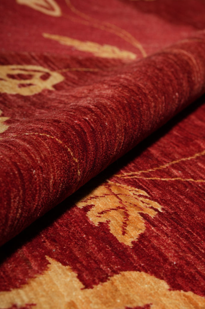 Close-up of red fabric with gold floral patterns