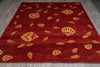 Load image into Gallery viewer, Red rug with gold floral patterns on a gray floor