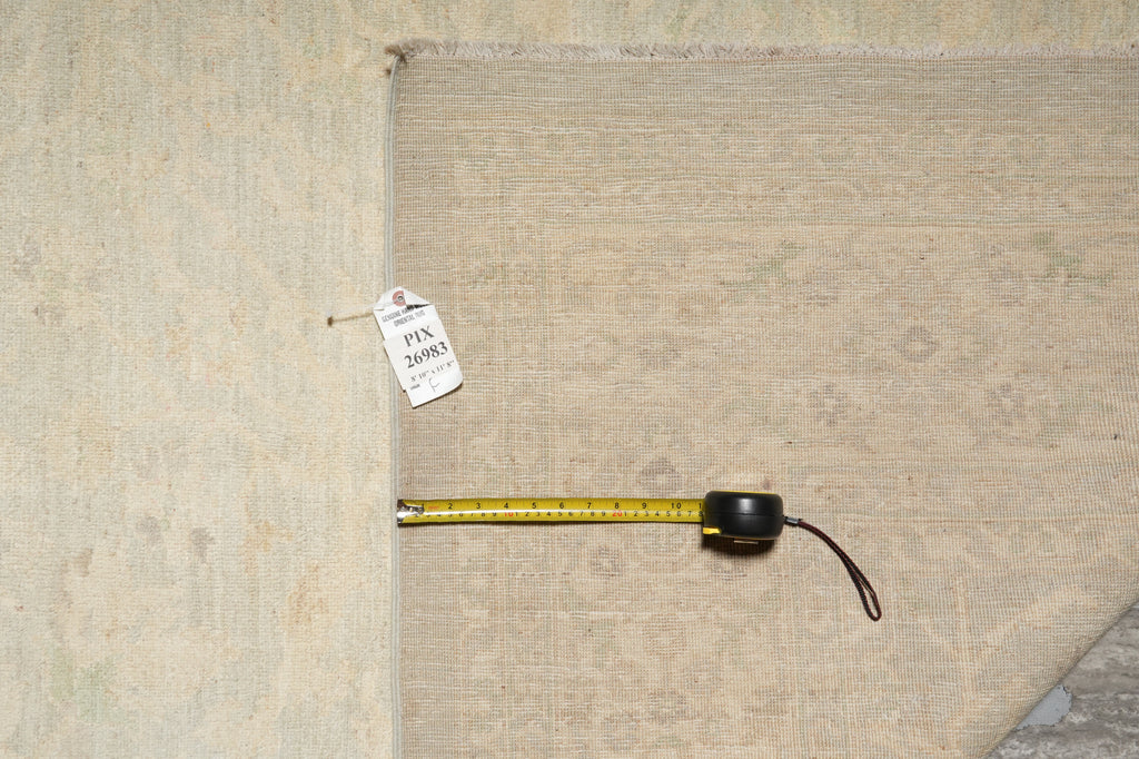 Measuring tape on a textured beige fabric with a visible label.