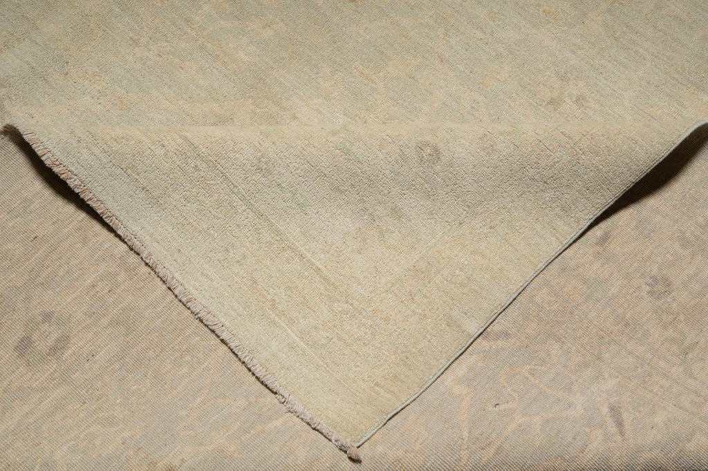 Close-up of a textured beige fabric with a visible seam.
