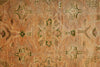 Load image into Gallery viewer, Close-up of a patterned rug with geometric designs on a warm-toned background