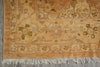 Load image into Gallery viewer, Close-up of a patterned rug with visible wear and tear on a concrete floor.