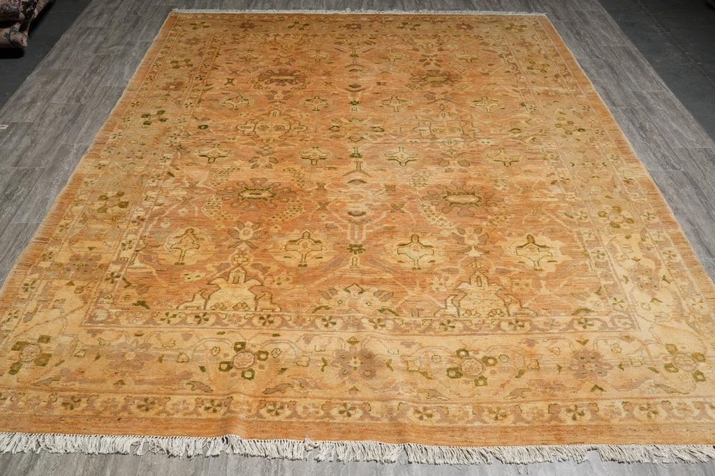 Decorative orange rug with intricate patterns on a wooden floor
