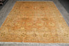 Load image into Gallery viewer, Decorative orange rug with intricate patterns on a wooden floor